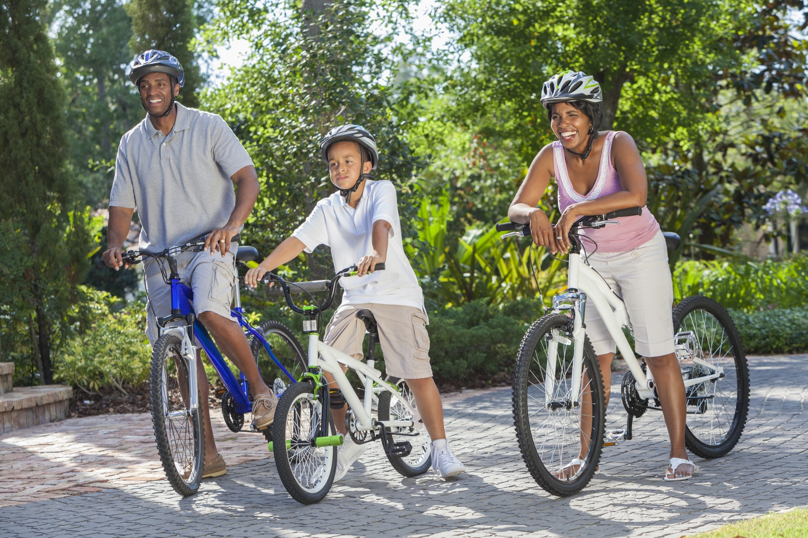 Mom, dad, & son on bikes wearing helmets shutterstock_117289561.jpg