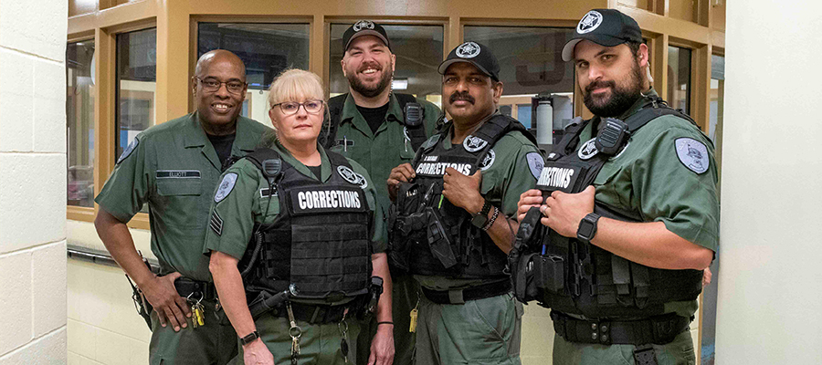 Five corrections officers standing together in the Clark County Jail