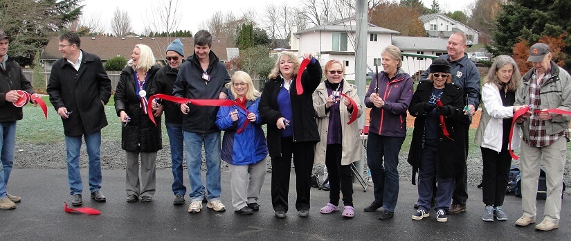 Members of the Felida Neighborhood Association cut a celebratory ribbon for the new park, Dec. 3, 2016.