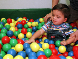 Baby playing in ball pit